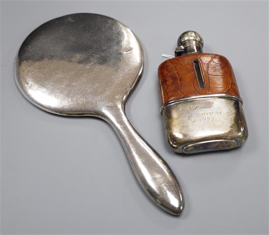 A George V silver and leather mounted glass hip flask, Mappin & Webb, Sheffield, 1921 and a silver mounted hand mirror.